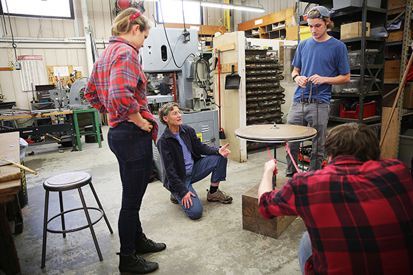 Students in Donna Cohn's Appropriate Technology in the World course work with the pearl millet thresher: From left to right, Sasha Moraski, Donna Cohn, Luke Richardson, Hayden Cifrino