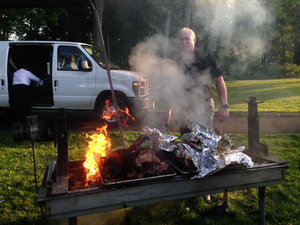 Jim is pictured with a Hampshire College hog that he butchered himself and prepared with an espresso barbeque rub.
