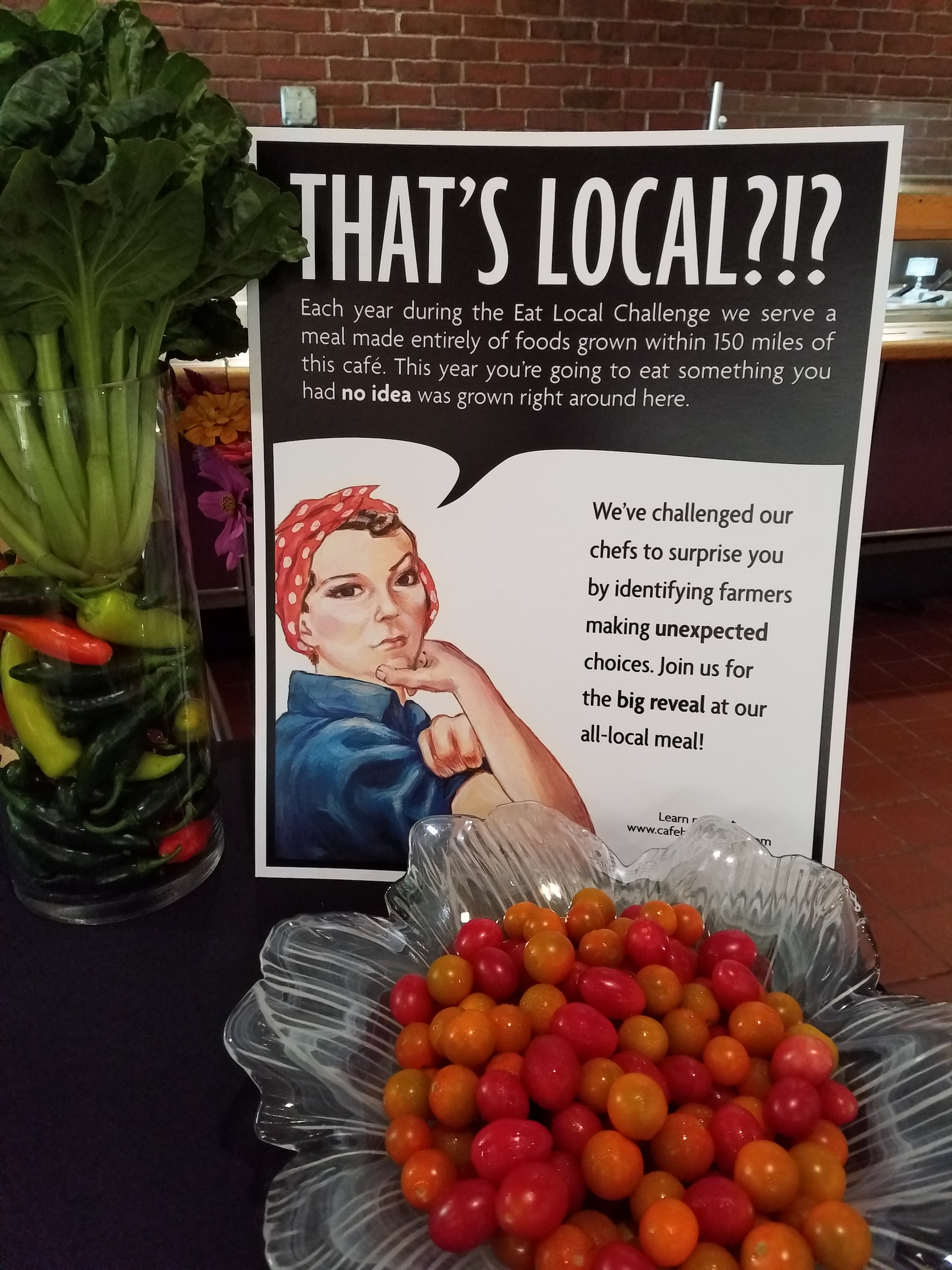 "That's Local?!? poster on table with bowl of cherry tomatoes