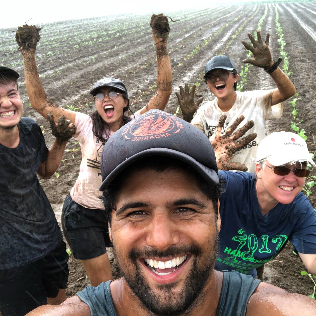 group of people in field covered in dirt