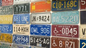 A display of license plates hanging on a wall