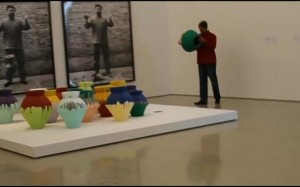 Maximo Caminero smashes a piece from Ai WeiWei's "Colored Vases."