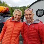 Couple in sportwear with arms around each other smile