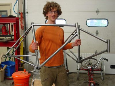 Student with two fabricated bike frames