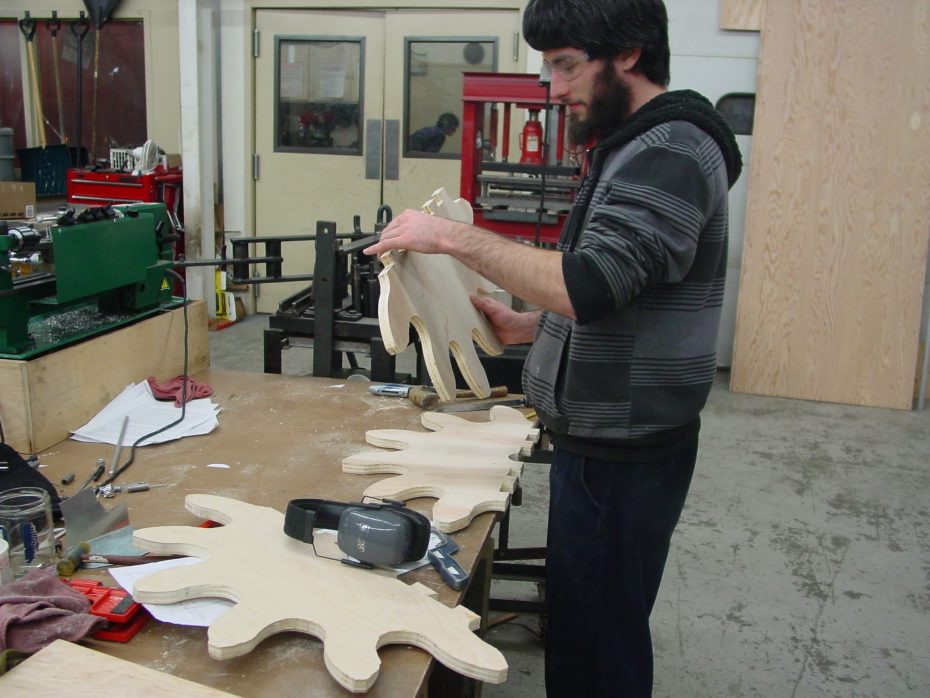 Student working on wooden gears