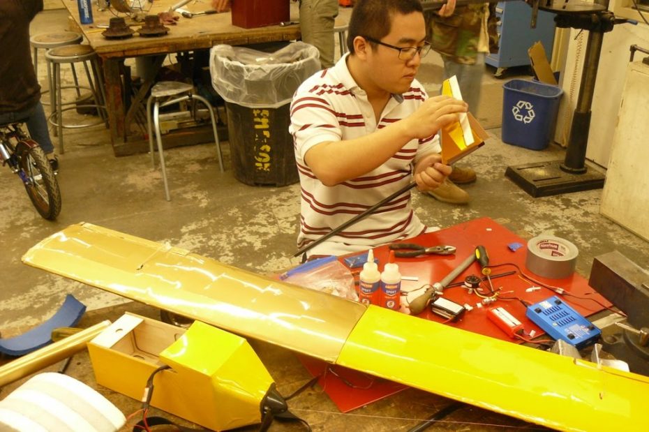Students working on remote control airplane