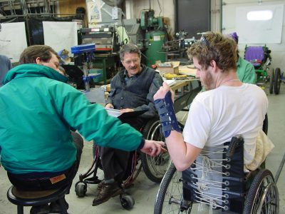 Student and faculty discussing wheelchair project