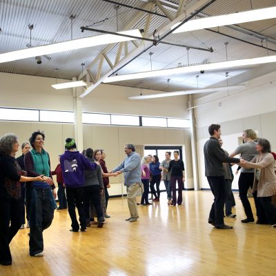participants in dance class move in pairs