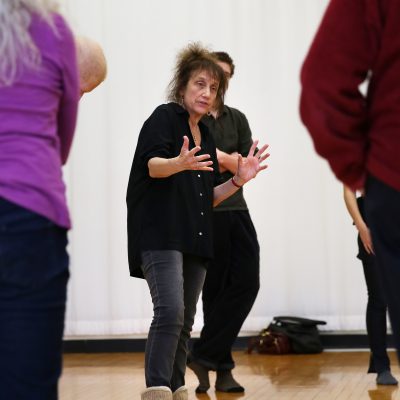 Liz Lerman with outstretched hands teaching