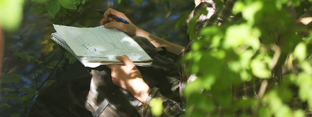 taking notes in the woods