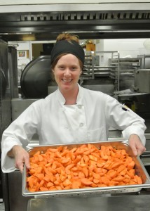 dining services worker with veggies