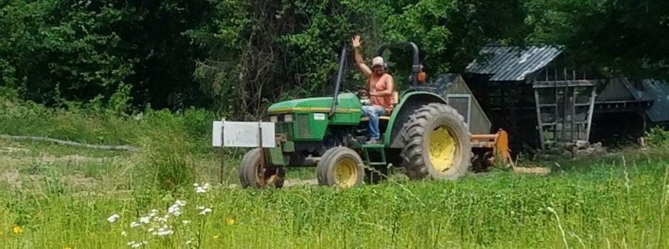 Farmer waving from tractor