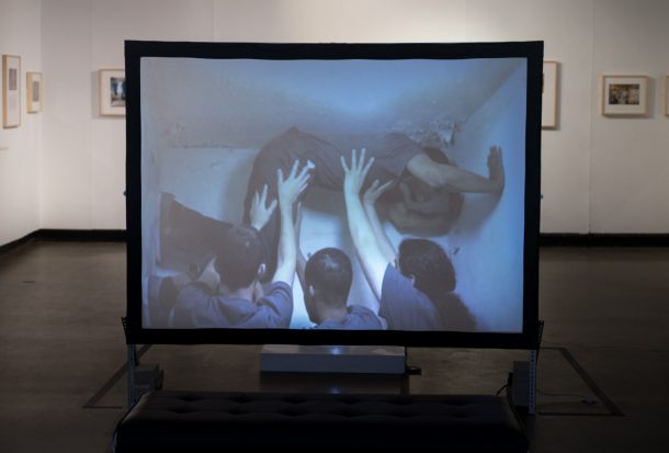 video installation still of dancers in a cell