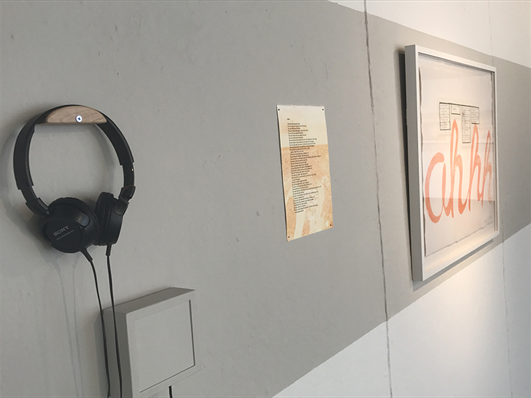 Installation of headphones and two prints
