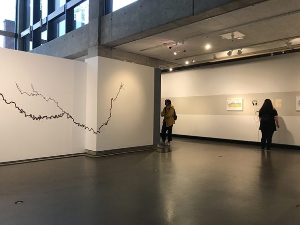 Installation view: Mississippie River laid on its side and series of prints