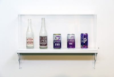 Shelf with a variety of Old Colony brand soda bottles