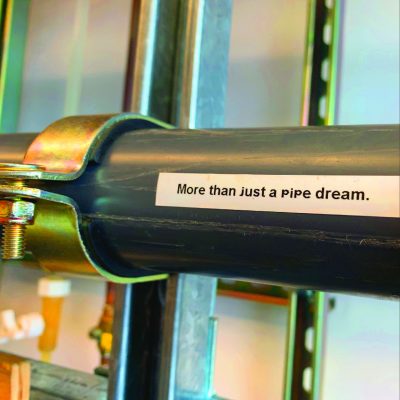 A picture of a pipe with a printed label which says "more than just a pipe dream"