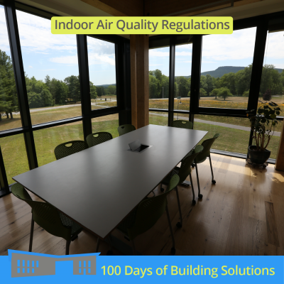 A panoramic view of lush, green trees, a wildflower meadow, and a mountain range can be seen through the windows of an R.W. Kern Center corner office. A large conference table surrounded by eight chairs sits inside the office. Text at the top of the image reads: Indoor Air Quality Regulations. A banner at the bottom of the image includes a simple shape of the R.W. Kern Center and reads: 100 Days of Building Solutions.