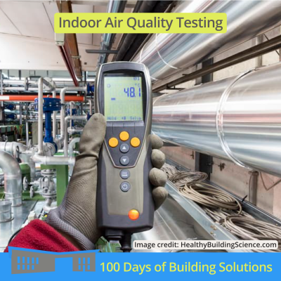 A POV photo of a person using equipment to take air quality measurements of an industrial room. A title at the top reads: indoor air quality testing. Small text on the bottom reads: image credit: HealthyBuildingScience.com. A banner at the bottom of the image includes a simple shape of the R.W. Kern Center and reads: 100 Days of Building Solutions.