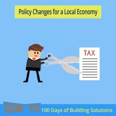 Text reads "Policy Changes for a Local Economy." above an image of a person with a comically large pair of scissors, cutting a comically large piece of paper titled "tax" right in half. A banner at the bottom of the image includes a simple shape of the R.W. Kern Center and reads: 100 Days of Building Solutions.