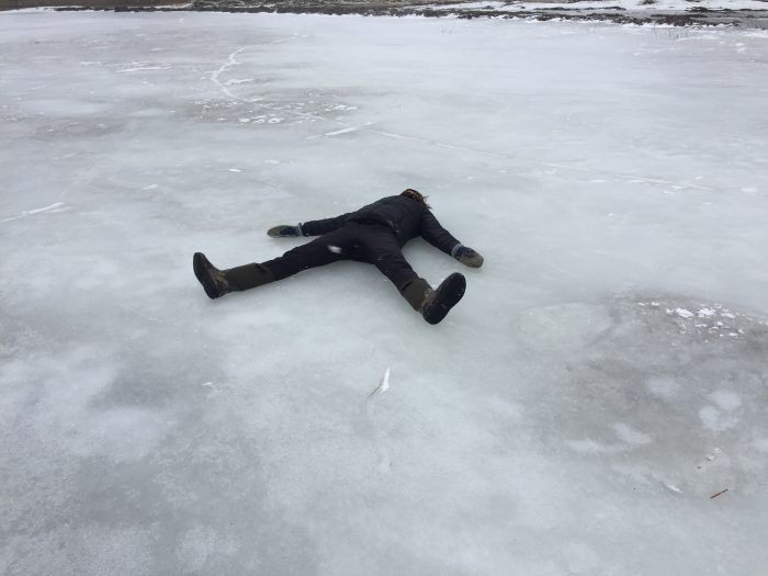 Student lying on the ice resting