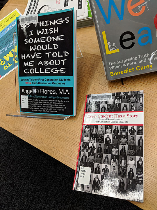 A photograph of some books for first-gen students on display